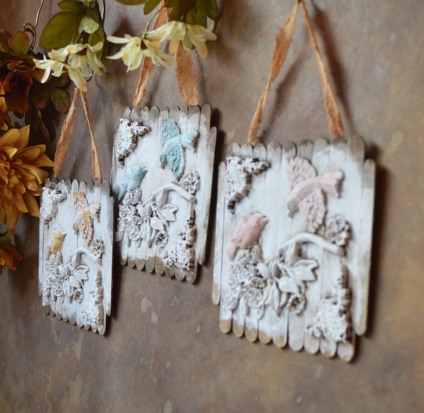 Ornate birds on a branch wall ornaments