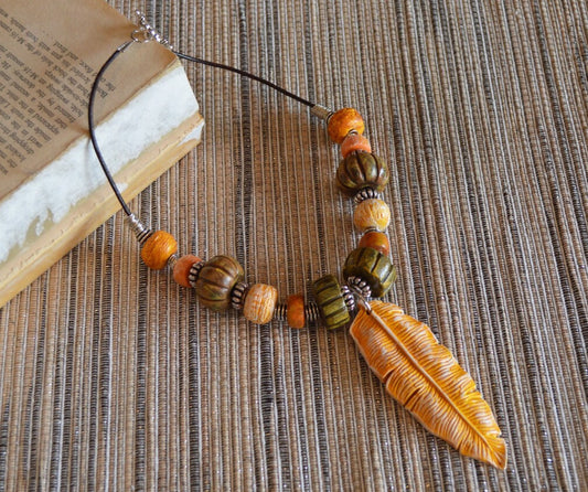 One of a kind statement beads polymer clay pendant necklace / earthy yellow feather