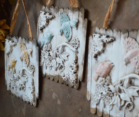 Ornate birds on a branch wall ornaments