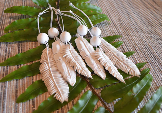 6 white feather shaped ornaments