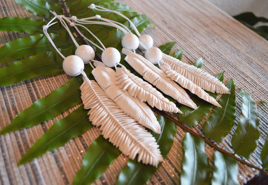 6 white feather shaped ornaments