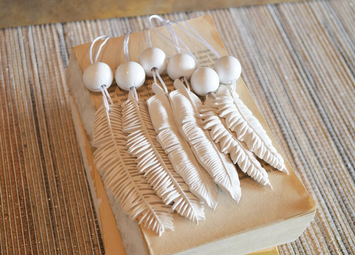 6 white feather shaped ornaments